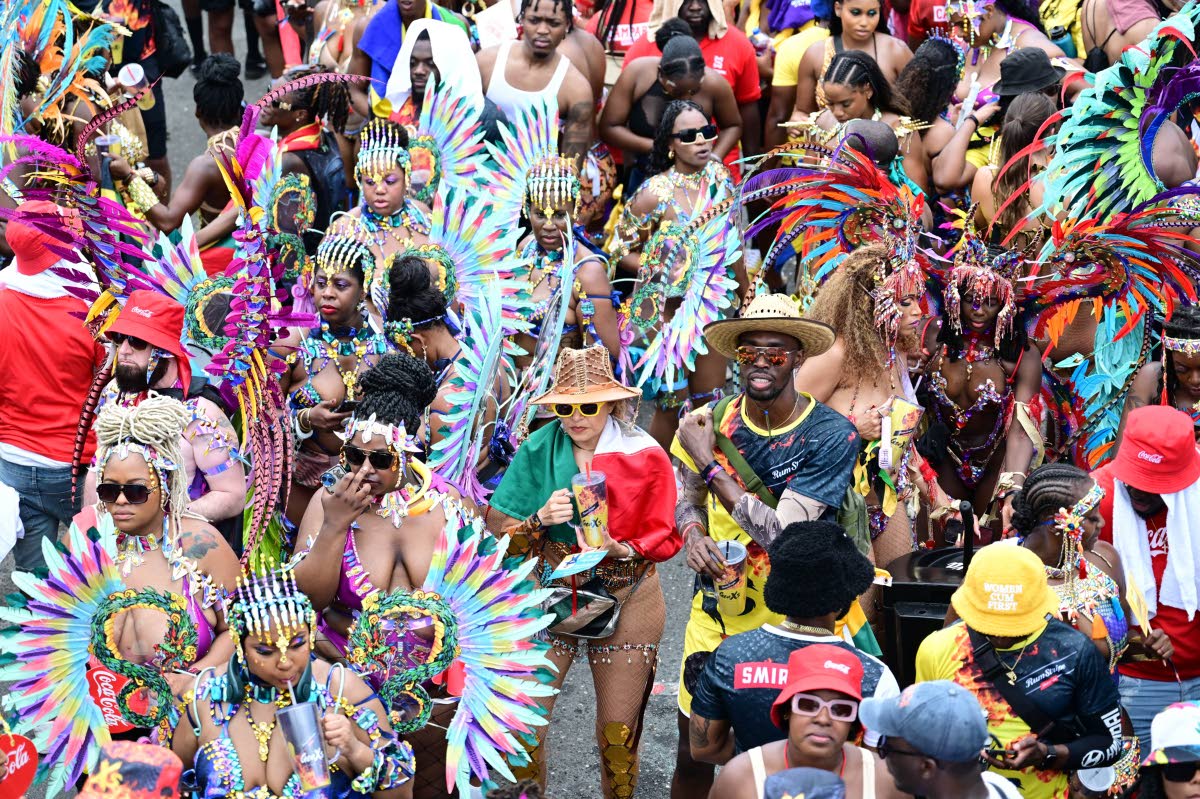 GenXs revellers on Worthington Avenue as they await the passing of the Xodus and Bacchanal and Yard Mas bands.GenXs revellers on Worthington Avenue as they await the passing of the Xodus and Bacchanal and Yard Mas bands.