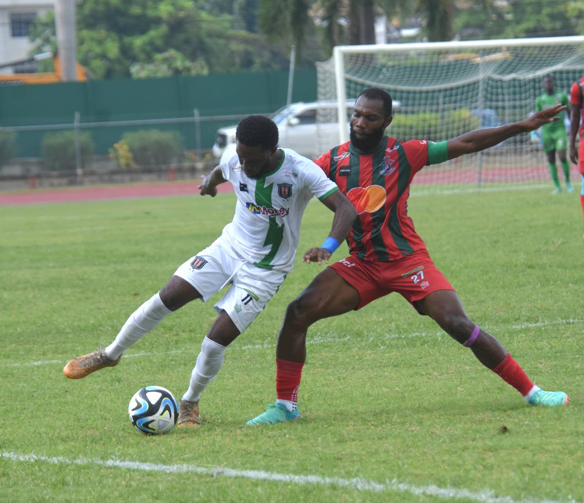 Anthony Nelson (left)  of Tivoli Gardens FC and Montego Bay United’s Owayne Gordon battle for the ball during their Wray and Nephew-sponsored Jamaica Premier League match at the Montego Bay Sports Complex yesterday. Montego Bay United won 2-1.