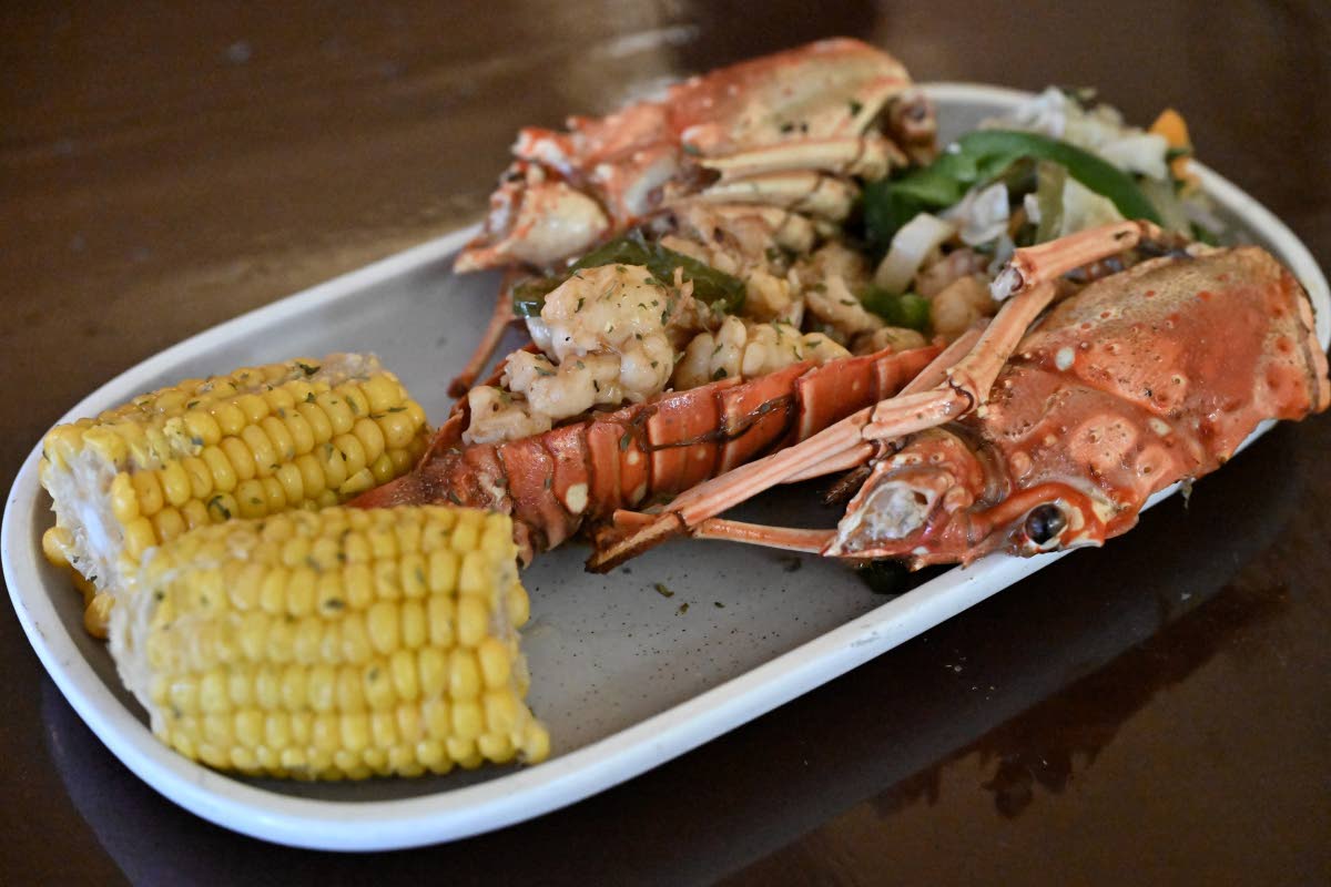 Feast your eyes on this amazing garlic lobster, served with a side of corn on the cob.