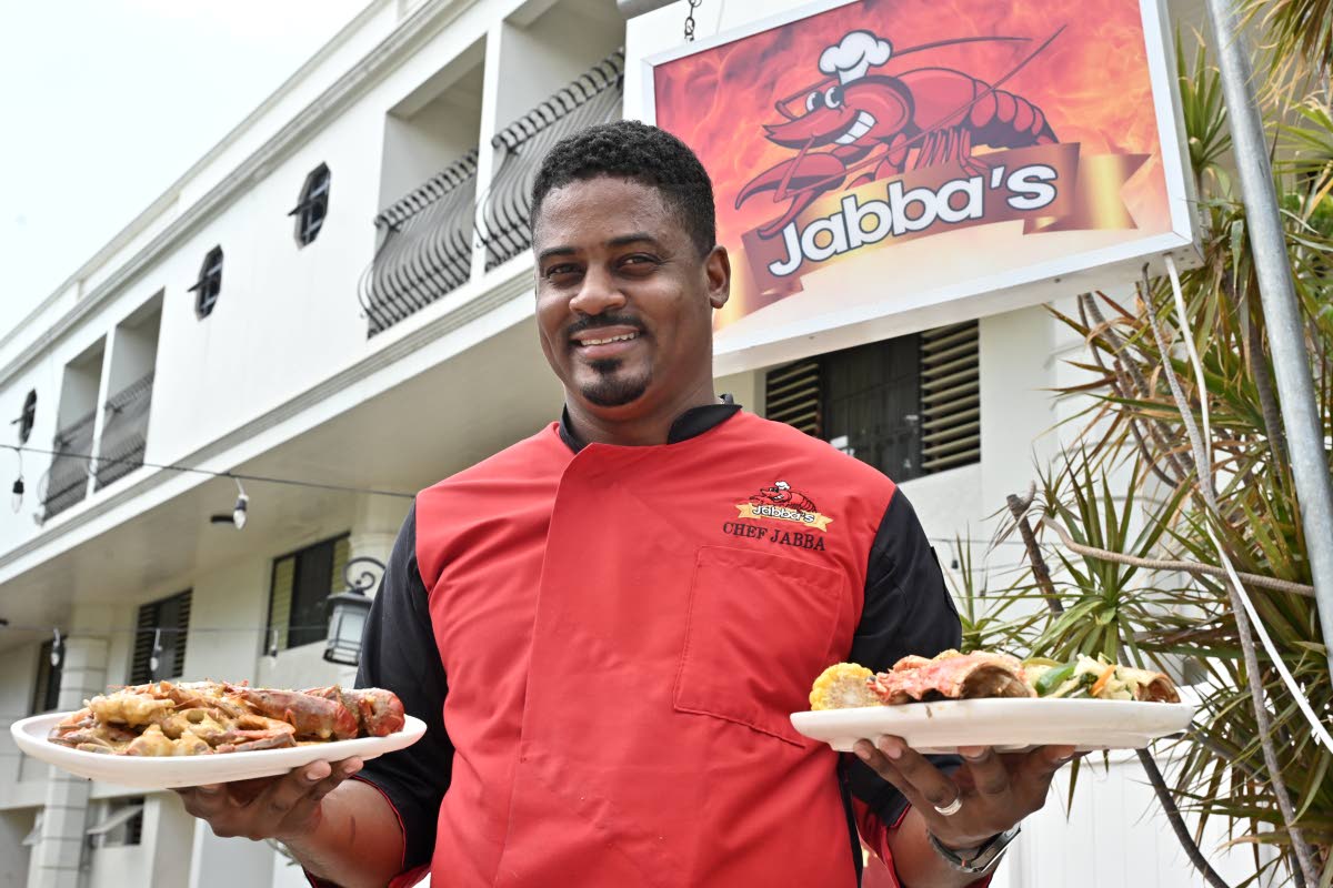 Chef Jonathan Simpson at Jabba’s Seafood and Grill showcases his seafood boil (left) and garlic lobster.