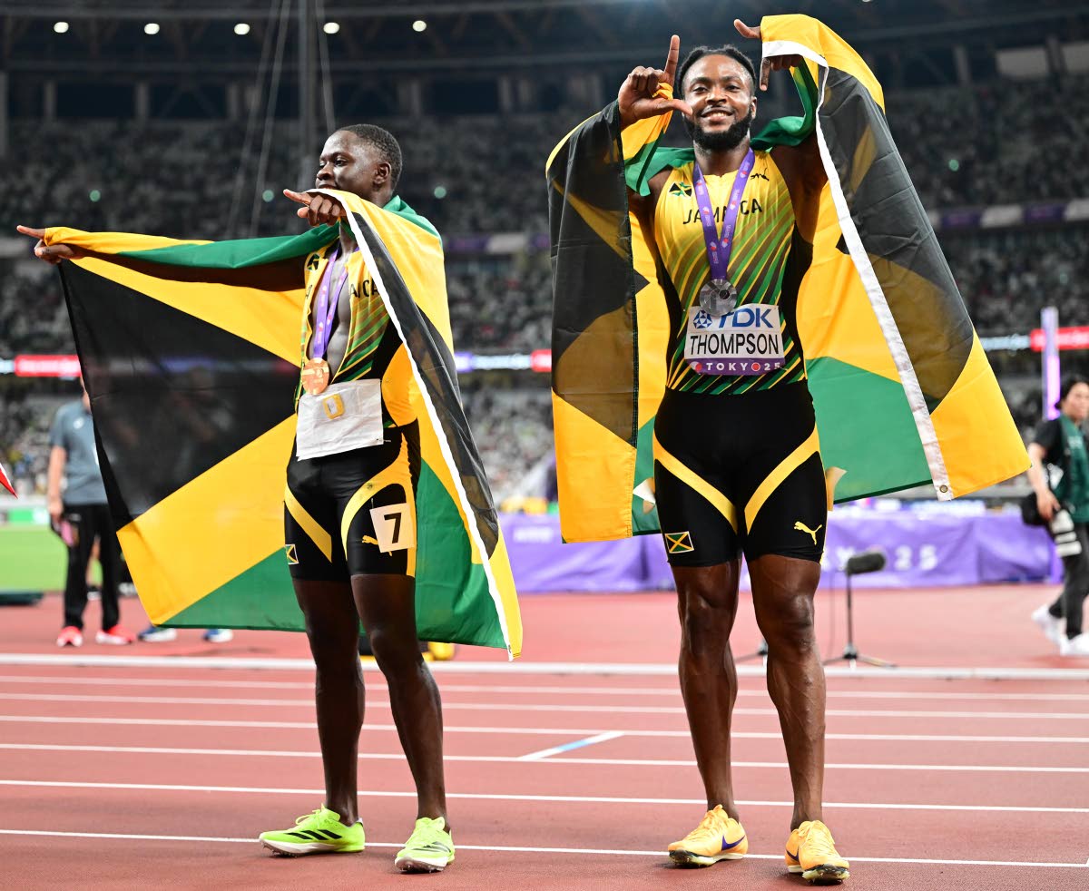 Oblique Seville (left), world champion in the 
men’s 100m, celebrates win with teammate and silver medalist Kishane Thompson.  