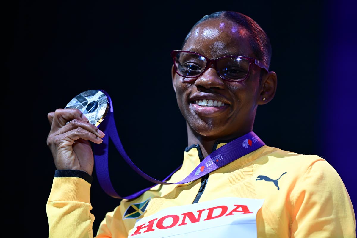 Tina Clayton is all smiles as she shows off the silver medal she won in the women’s 100 metres at the World Athletics Championships.