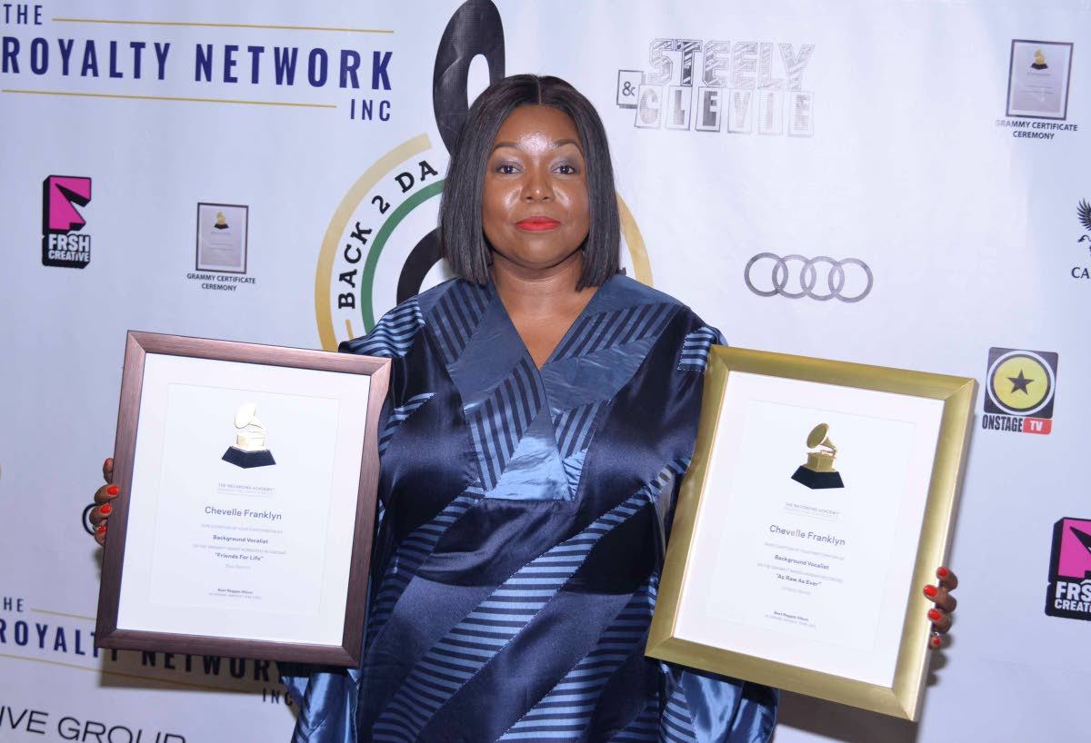Chevelle Franklyn poses with Grammy certificates on Saturday at the ceremony at the Audi Showroom.