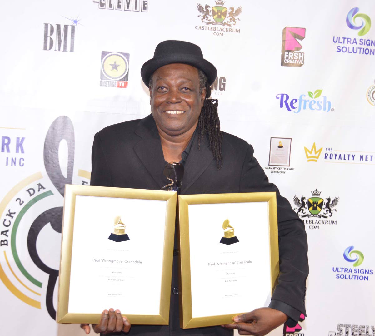 Paul Crossdale with his awards at the Grammy Certificate Ceremony held last Saturday at the Audi Showroom in New Kingston.
