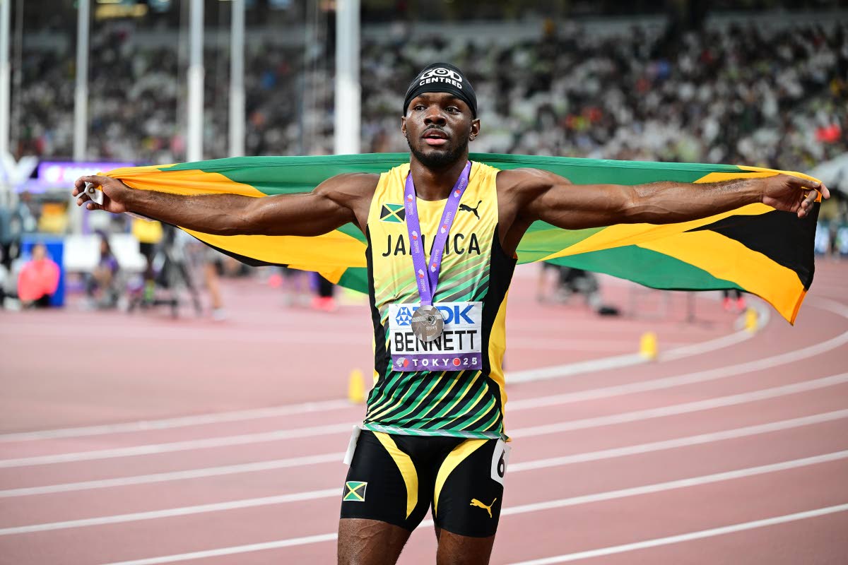 Orlando Bennett celebrates the 110-metre hurdles silver medal he won yesterday.