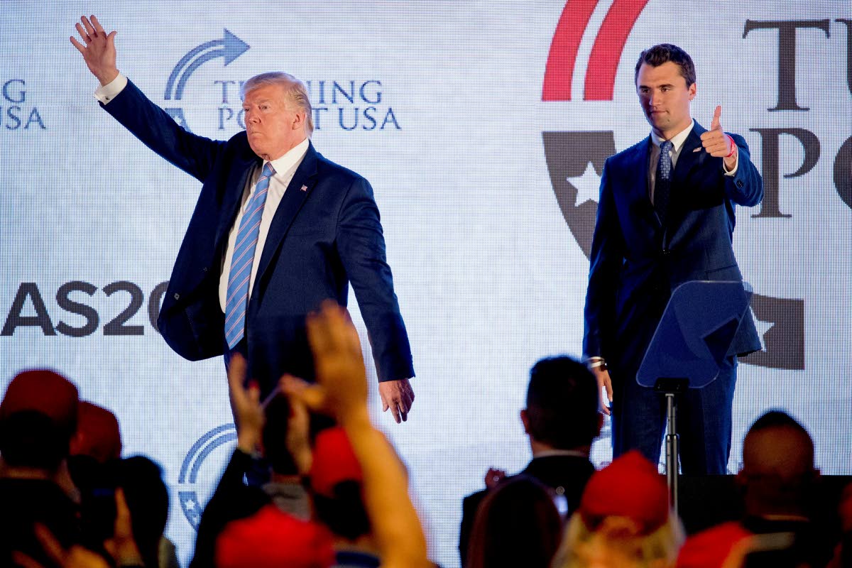 President Donald Trump (left) is joined on stage by Turning Point USA founder Charlie Kirk as he concludes his speech at the Marriott Marquis in Washington, D.C., on July 23, 2019.