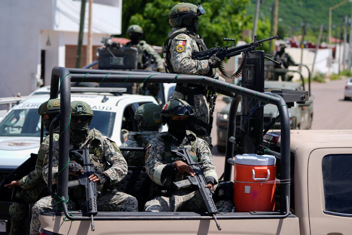 National Guards and Army forces patrol the streets during an operation in a neighborhood of Culiacan, Sinaloa state, Mexico, Thursday, Sept. 19, 2024. 