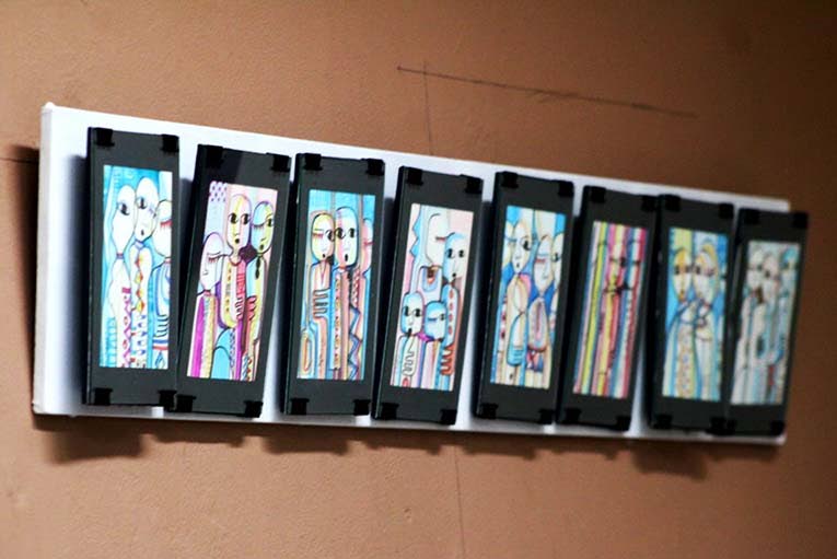 The work of Alao Luqman Omotayo lines the wall. 