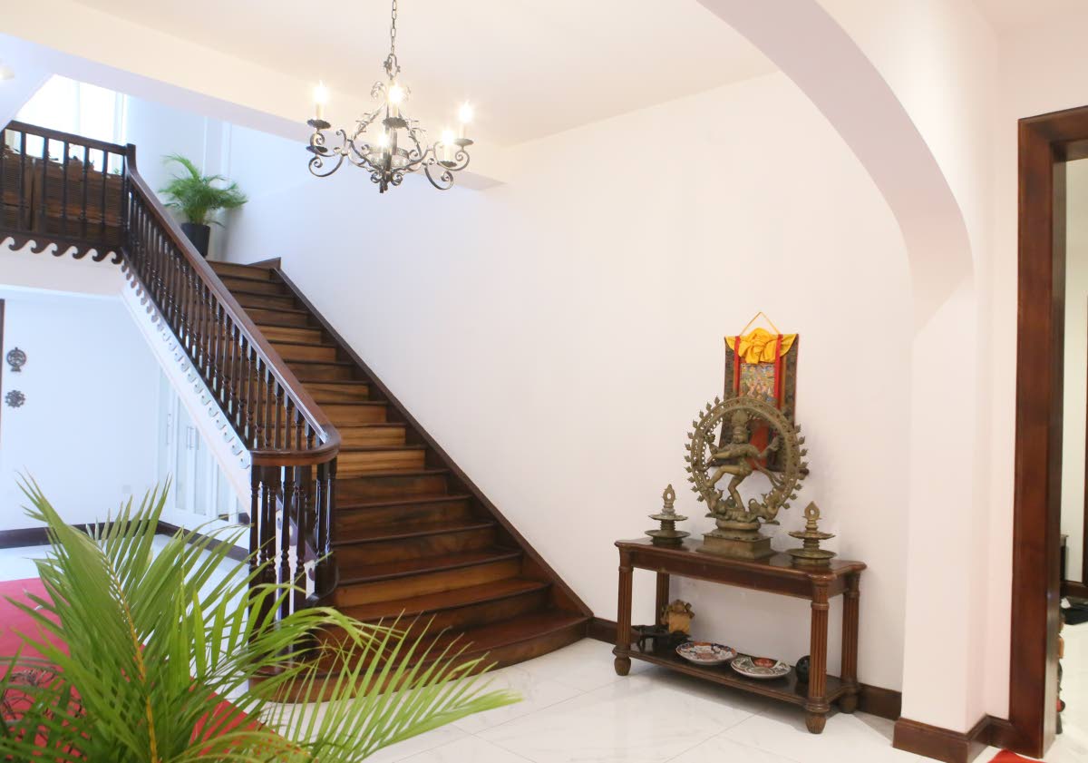 The main mahogany staircase rises in elegance to the next level.
