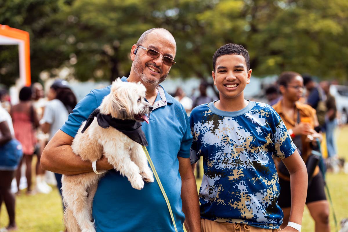 Andrew McCreath (left) from MacTours Ltd and his son Dominic pose with their dog, Charlie, at the last Yappy Hour held in March on the grounds of Immaculate Conception High. The next doggie social is scheduled for Sunday, September 28, at the Jamaica Horti