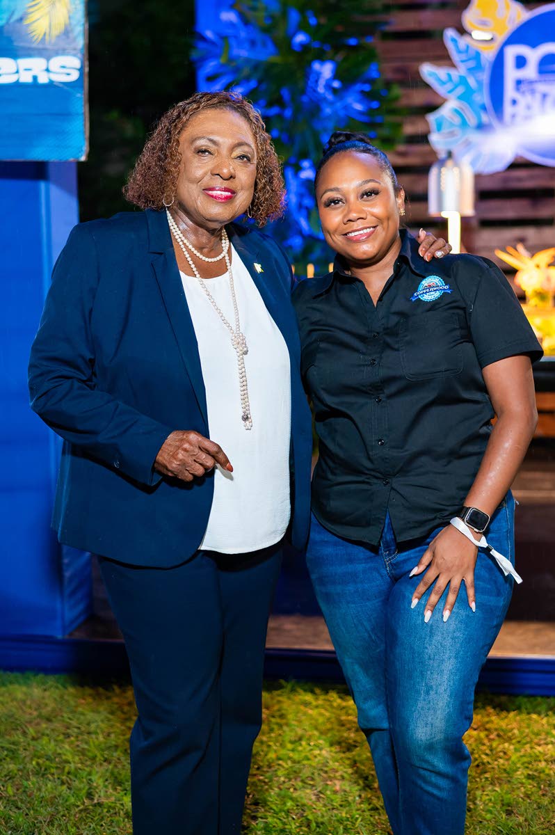  Culture Minister Olivia Grange and Samantha Fisher, assistant brand manager CB Foods, share lens time at the launch of the Jamaica Food and Drink Festival