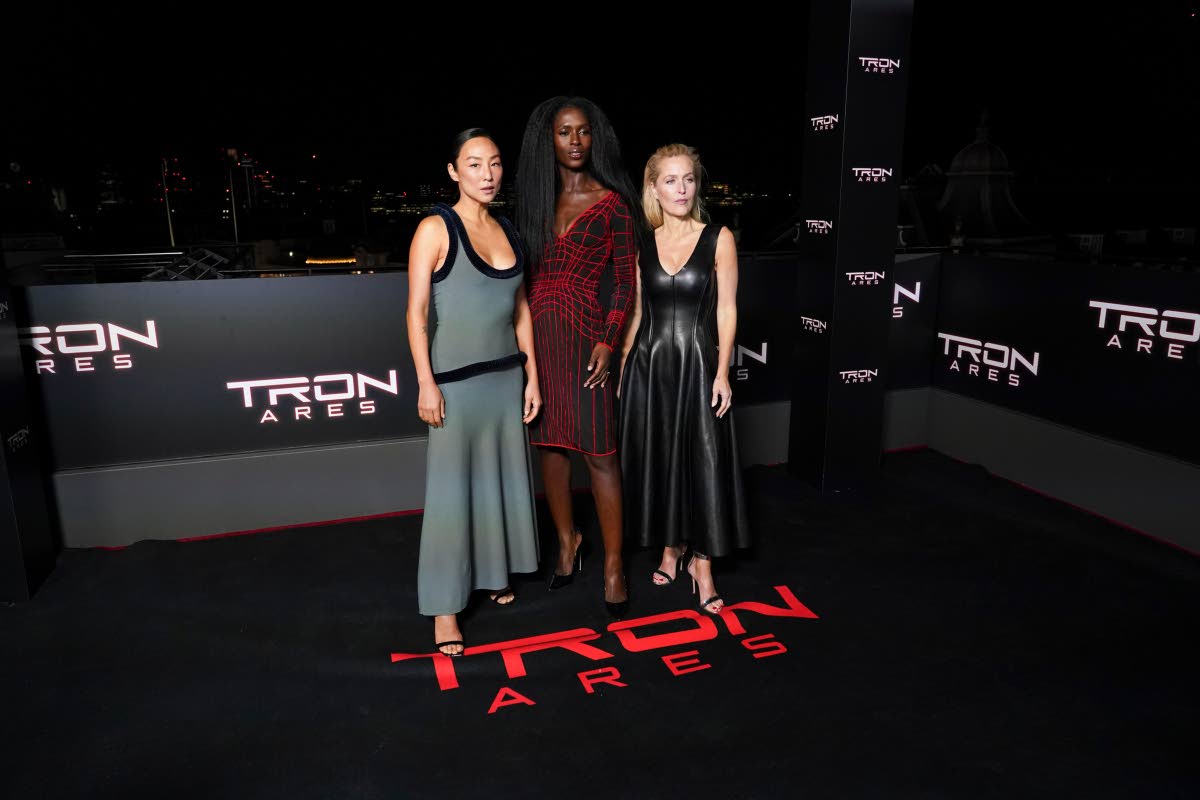 From left: Greta Lee, Jodie Turner-Smith and Gillian Anderson pose for photographers upon arrival at the premiere of the film ‘Tron: Ares’ on Wednesday, in London.