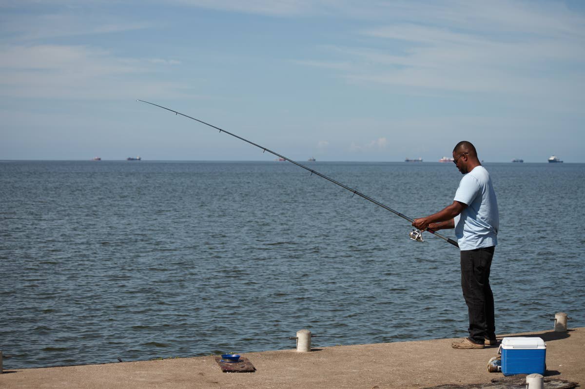 A man fishes in Cocorite, Trinidad and Tobago.