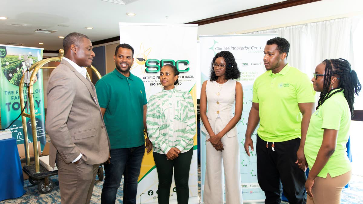 From left: Carlinton Burrell, CEO of the Caribbean Climate Innovation Centre (CCIC), addresses the winners of the ScaleItUp Accelerator Demo Day pitch competition. John Mark Clayton and Kerri Anne Gray (Towerfarms Limited), Joanna Anderson (Phinetic) and D