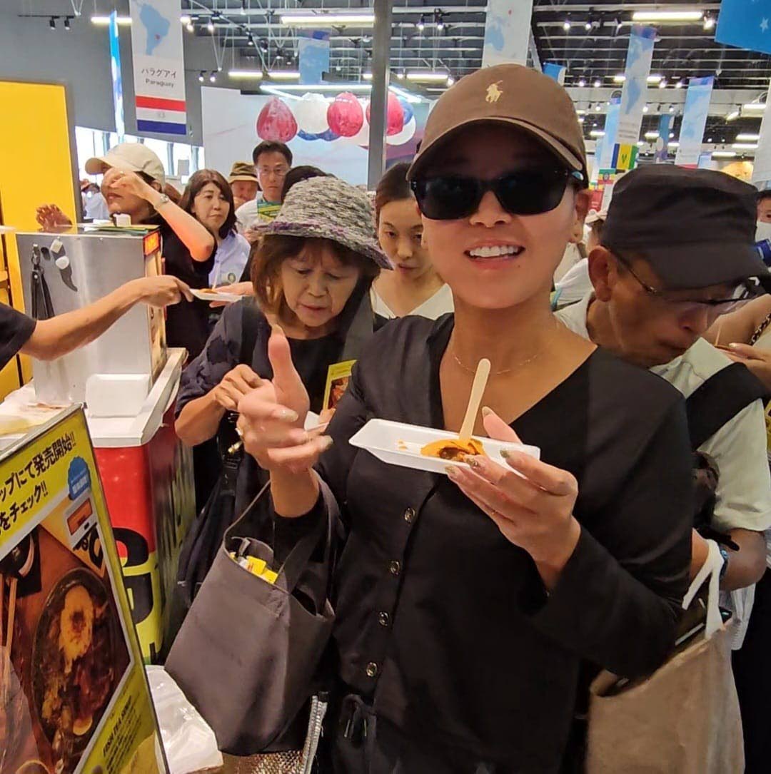 A visitor to the Jamaica Pavilion at Expo 2025 Osaka, Kansai, Japan, gives the beef patty a thumbs-up after taking a bite at the sampling event, held at the Jamaica Pavilion on October 7. The patties were presented by Gangalee Kitchen, a Jamaican Restauran