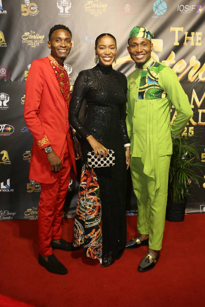  Levy’s Heritage’s Oshin Levy, in a black, floor-length sequinned gown from her closet, is flanked by brothers and group mates Oneil (left) and Ovando.