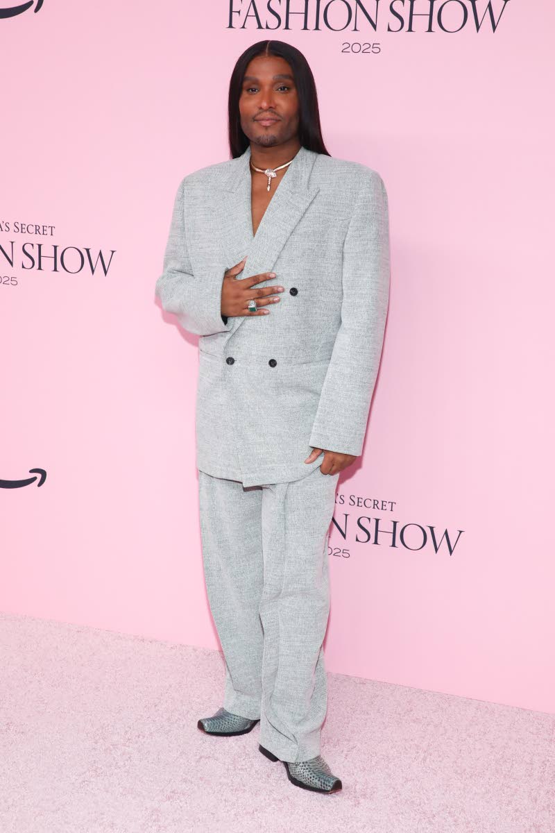 Stylist and image architect Law Roach wears a silver suit and matching snakeskin boots. 