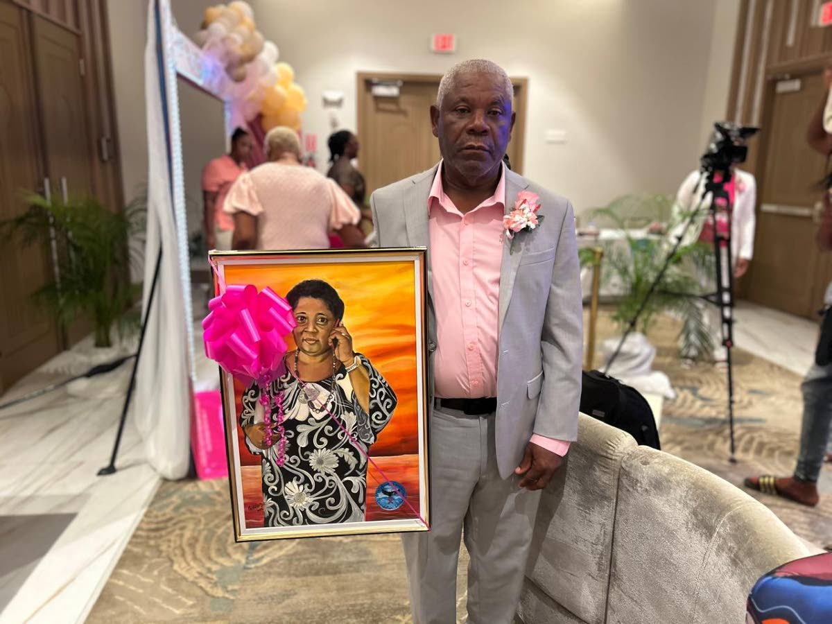Kelvin Gifford, husband of the late Faith Gifford, with Faith’s portrait, a gift from the Misty Blue Foundation.