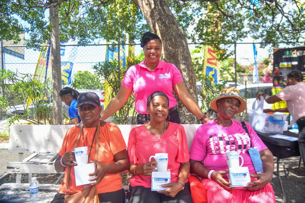
Tatum Murray-Lowe Chin (standing) from Dean’s Pharmacy takes a photograph with cancer survivors Maxine Johnson (left), Nurrel Anderson (centre), and Alberta Plumber at the World Mammography Day celebration at the Jamaica Cancer Society in St Andrew on F