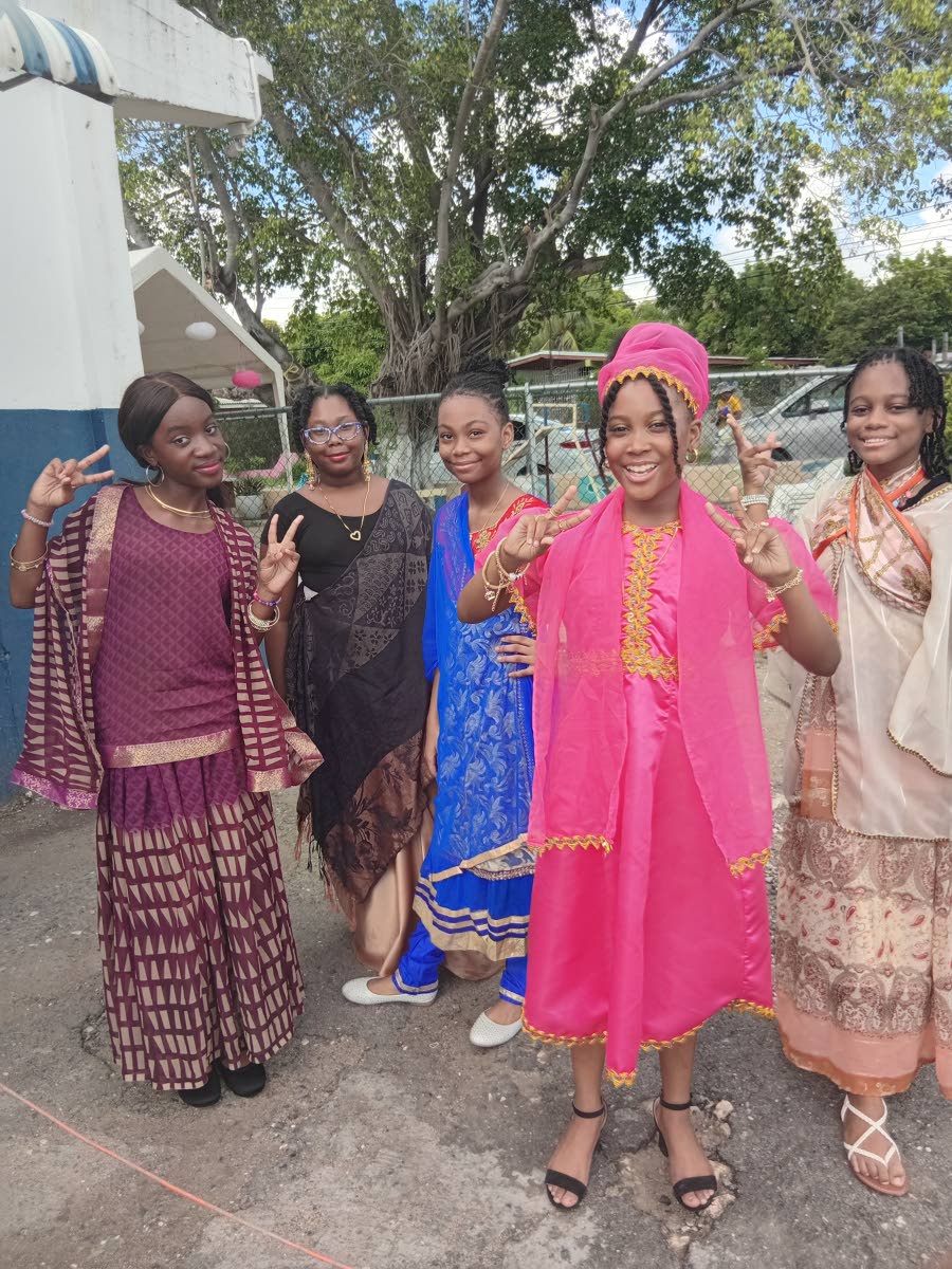 Harrison’s Preparatory students dressed in traditional attire pose for a photo during Heritage Week celebrations.