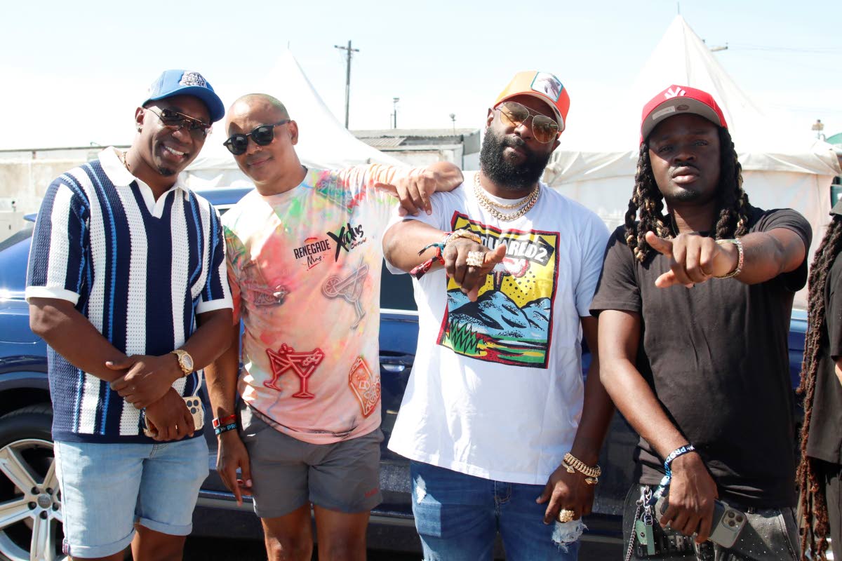 From left: DJ Bravo, Scott Dunn, group managing director of Dream Entertainment Ltd., Bunji Garlin and Gabbidon were captured lyming backstage at Xodus Wet Music Festival .