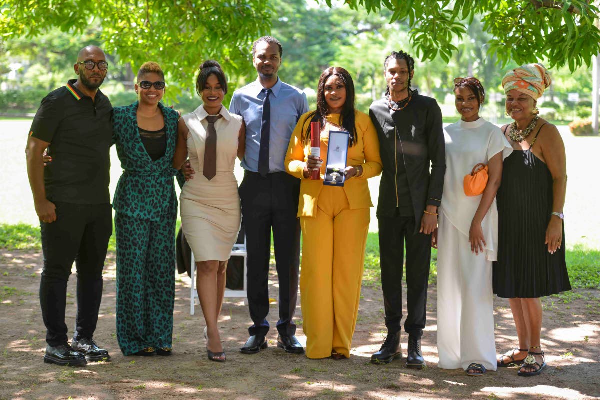 Family and friends of the late Garnett Silk celebrate his posthumous OD. From left: Delroy Collins; Kemilee McLymont; Arrayma Smith (daughter); Fabian Smith (son); Novlyn Banton (spouse); Garnet Smith (son); Wayzero Smith (daughter) and former manager Brid