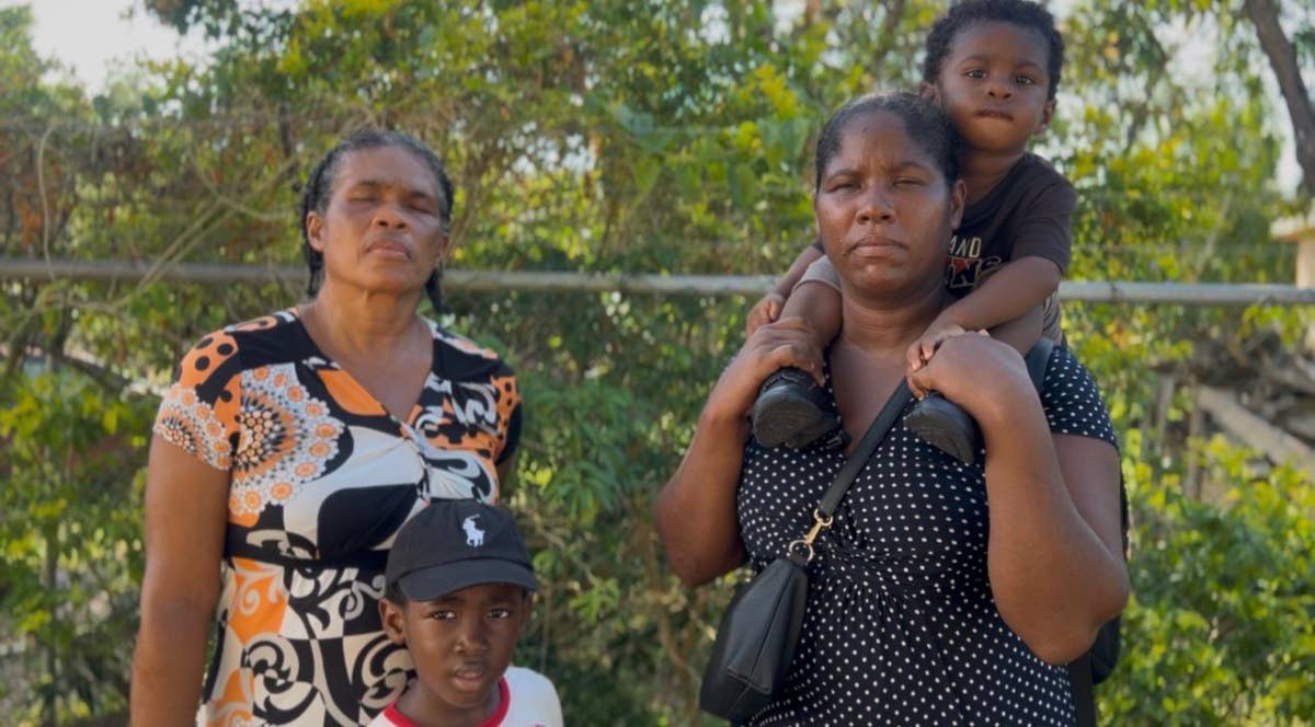 Resident of McNeils Land, Siana Moodie-Brooks, alongside her mother and children, says the communities’ biggest concern should be working on the culvert where water often overflows and makes the roadway impassable.
