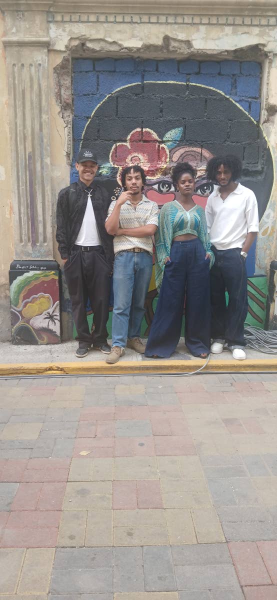 Alisha Thorpe, CEO of My Model University, is surrounded by three of her male models (from left): Izy Isaacs, Zari Maddix and Husani Dixon. 