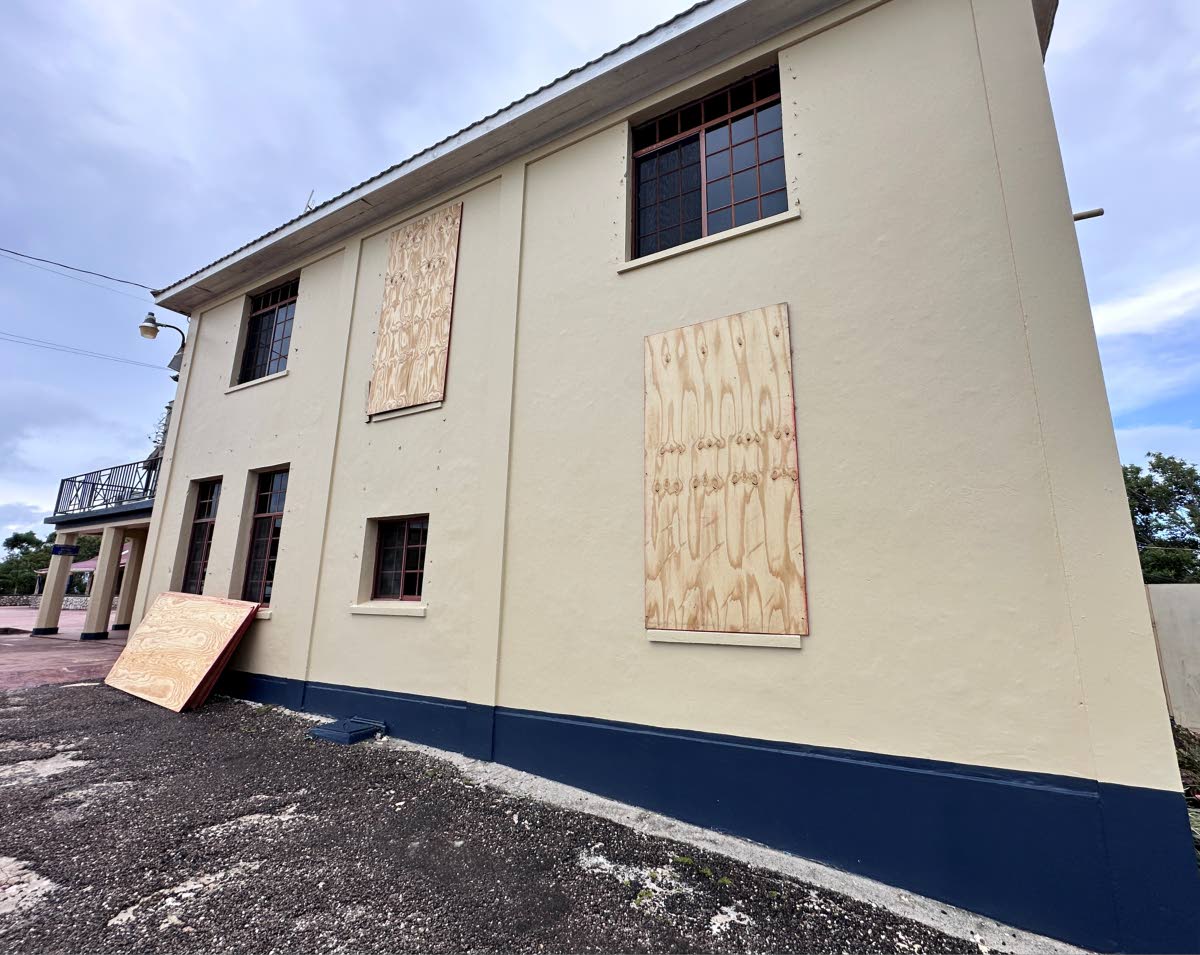 Windows at Munro College being secured ahead of the arrival of Hurricane Melissa.