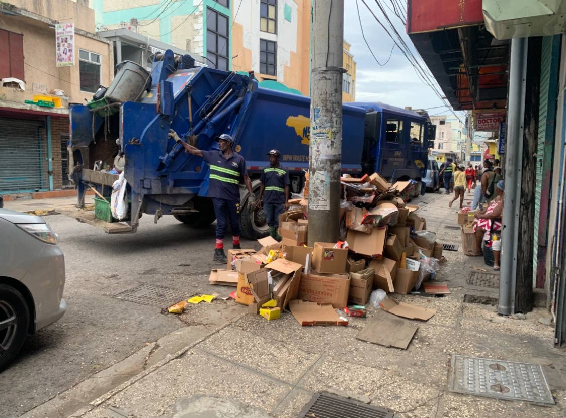 Sanitation workers collecting garbage in a section of the Second City on Monday ahead of the passage of Hurricane Melissa.