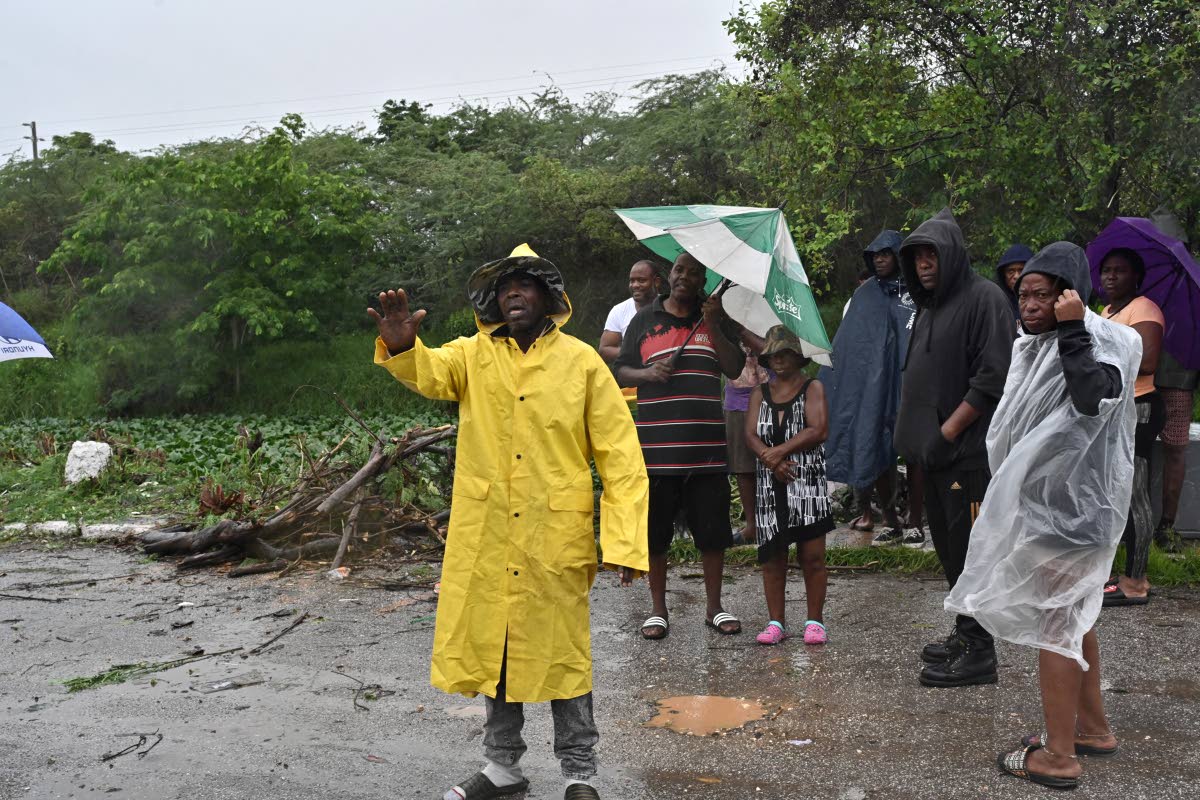 Waterford residents protest neglect of Adair Drive gully ahead of Hurricane Melissa on Monday.