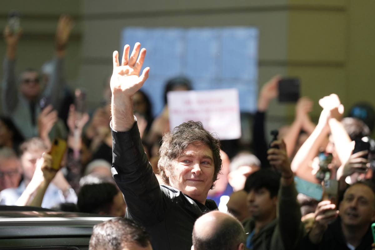 Argentina’s President Javier Milei waves to supporters after voting during legislative midterm elections in Buenos Aires, Argentina, Sunday, October 26, 2025.