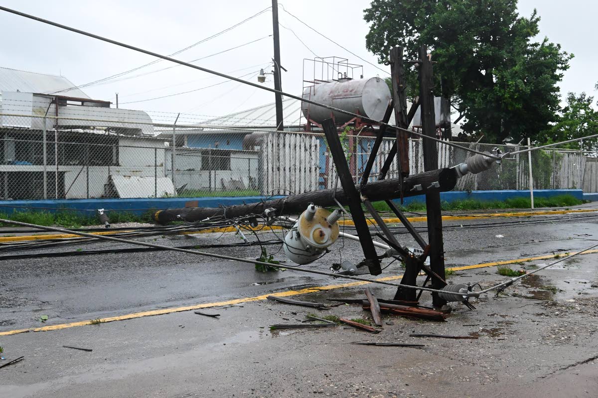 A downed power pole in the vicinity of the Bustamante Hospital for Children on Arthur Wint Drive in St Andrew yesterday.