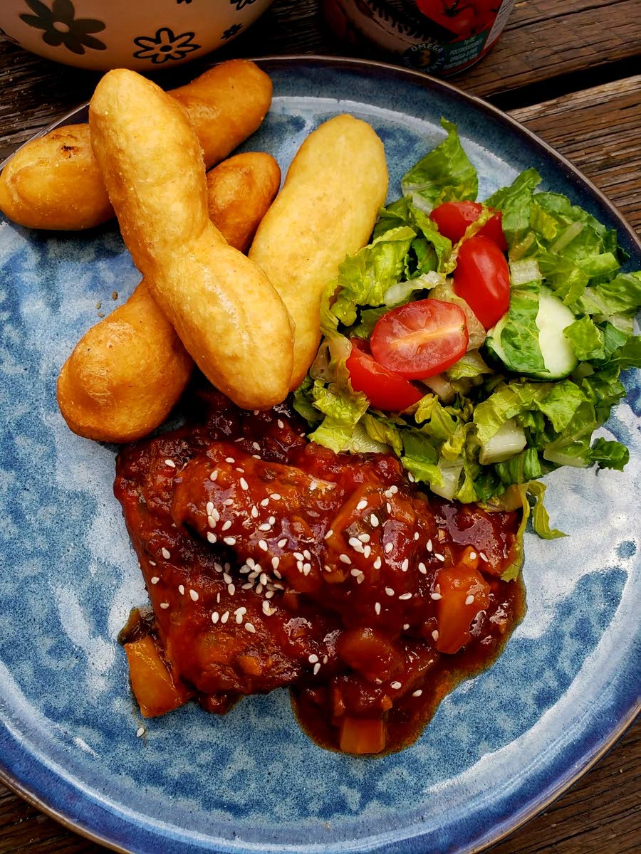 This sweet and sour mackerel, topped with sesame seeds, was paired with fried festival and a side of garden vegetables.
