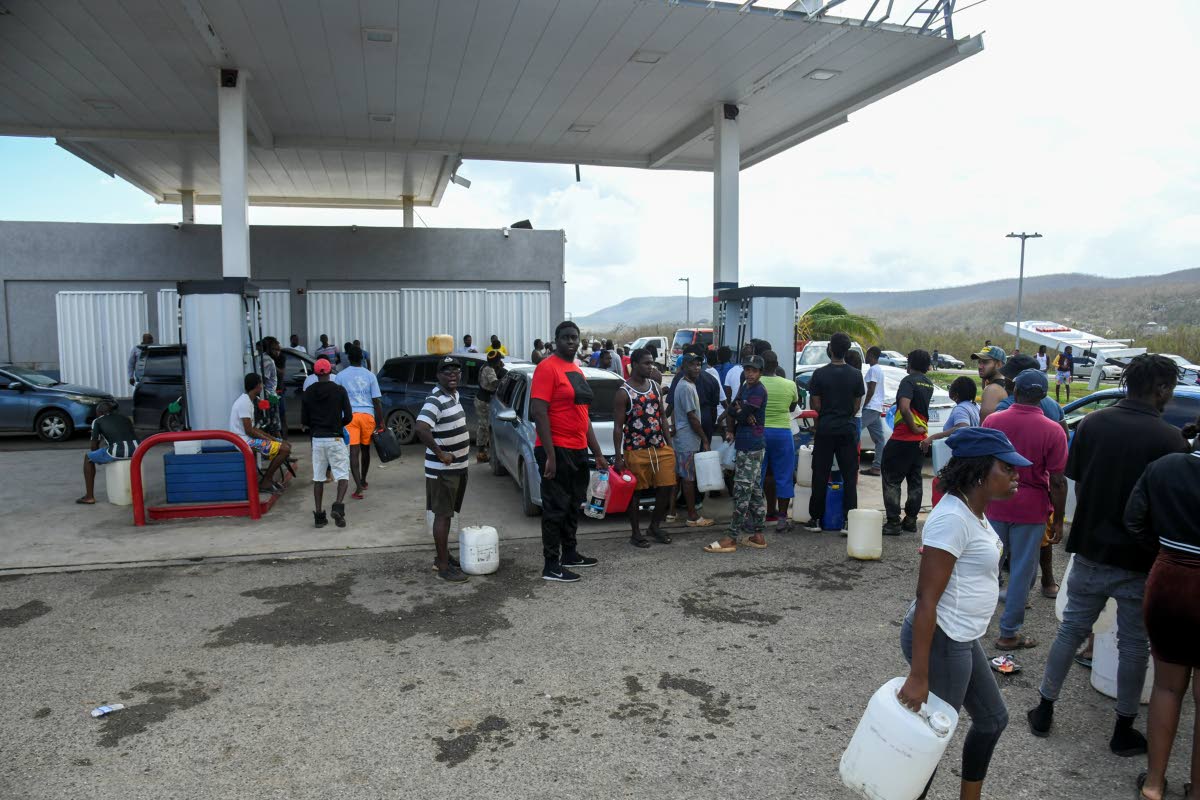 Crowds gather at the Flamingo gas station along the Salt Marsh main road in Trelawny last week. 