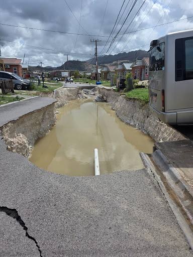 Right: A damaged road in The Estuary, St James.
