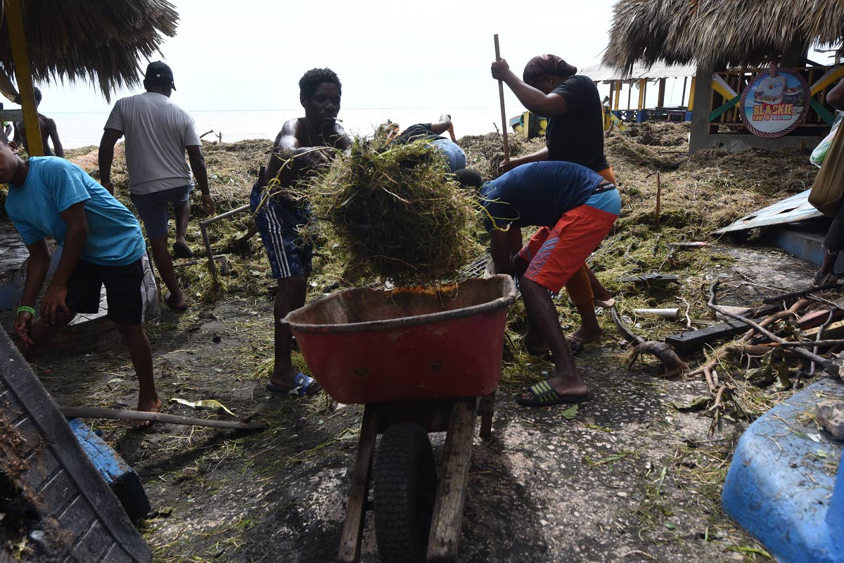 It’s all hands on deck as residents of Alligator Pond gather to clean up Little Ochie Seafood Restaurant in Manchester.