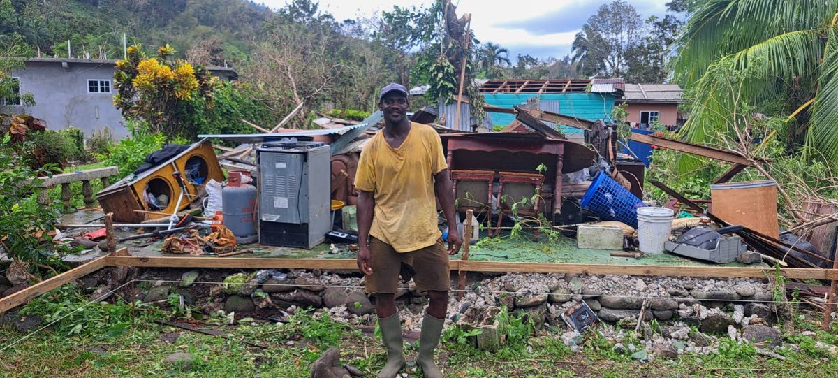 Duane Bryan stands in front of his flattened home in Comfort Castle, Portland, on Thursday, after Hurricane Melissa swept through.