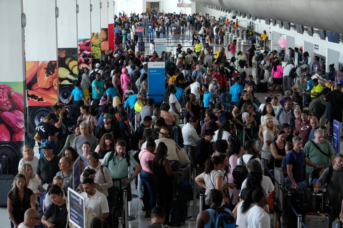 Passengers check in at the Norman Manley International Airport in Kingston, Jamaica, Saturday, November 1, in the aftermath of Hurricane Melissa. 