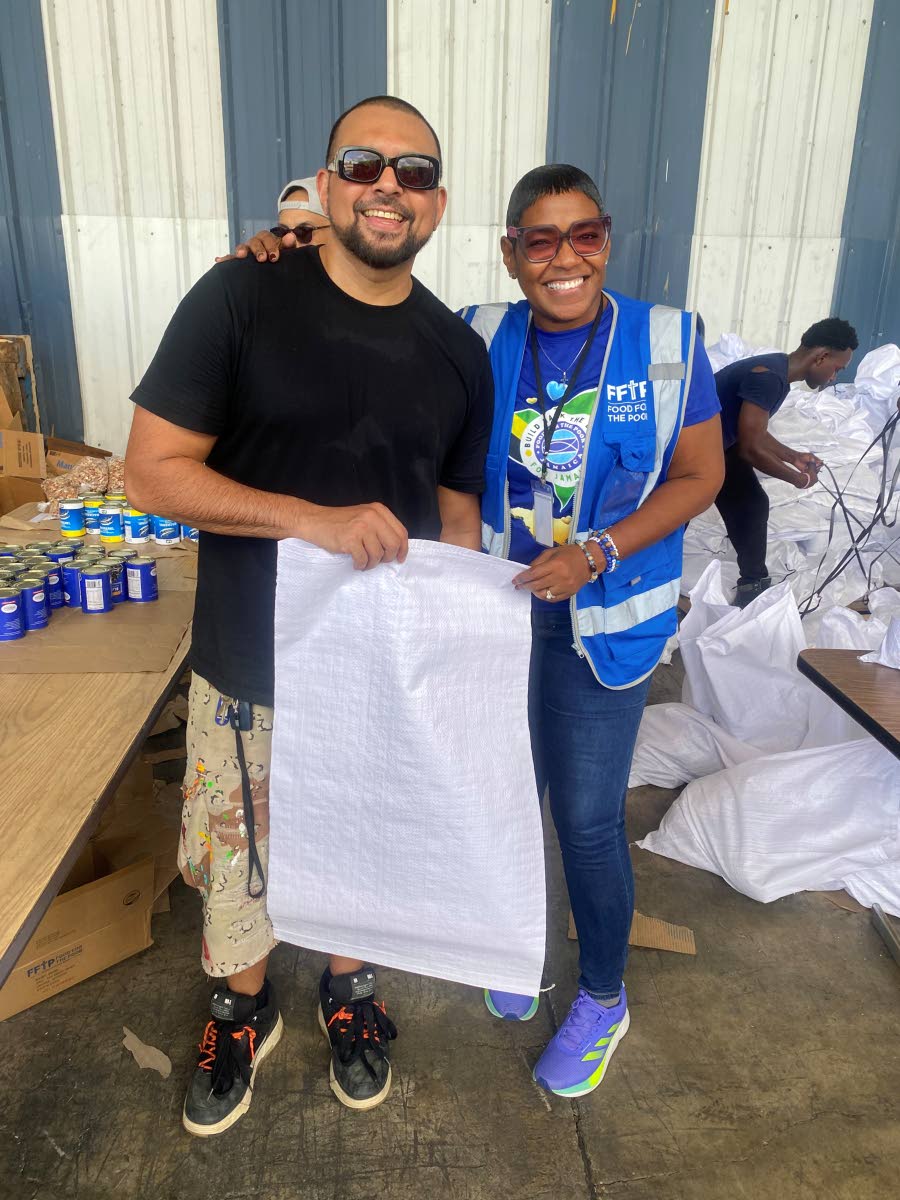 Sean Paul and Marsha Burrell-Rose, marketing, PR and missions manager at Food For The Poor (FFTP) Jamaica keep up the positive energy as the teams worked together to put together relief packages. VP Music Group has now partnered with FFTP to help rebuild J