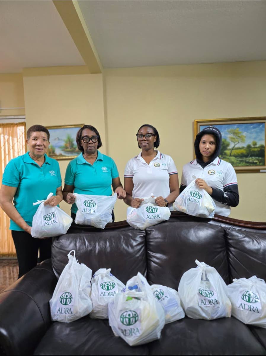 ADRA Jamaica volunteers (from left) Nazrene Nathan, Imogene McCallum, Georgia McCallum and Tamia Nathan with packaged food supplies ahead of the landfall of Hurricane Melissa.