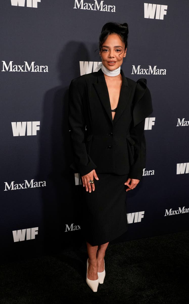 Actress Tessa Thompson, recipient of the Crystal Award for Advocacy in Film, breaks up her structured black skirt suit with a white scarf and matching pumps. 