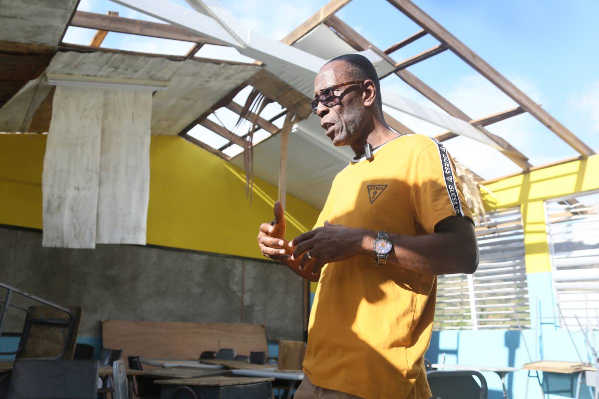 
Reverend Winston Pecco, chairman of Edwin Allen High School in Clarendon, explaining the extent of the damage caused by Hurricane Melissa at the institution.