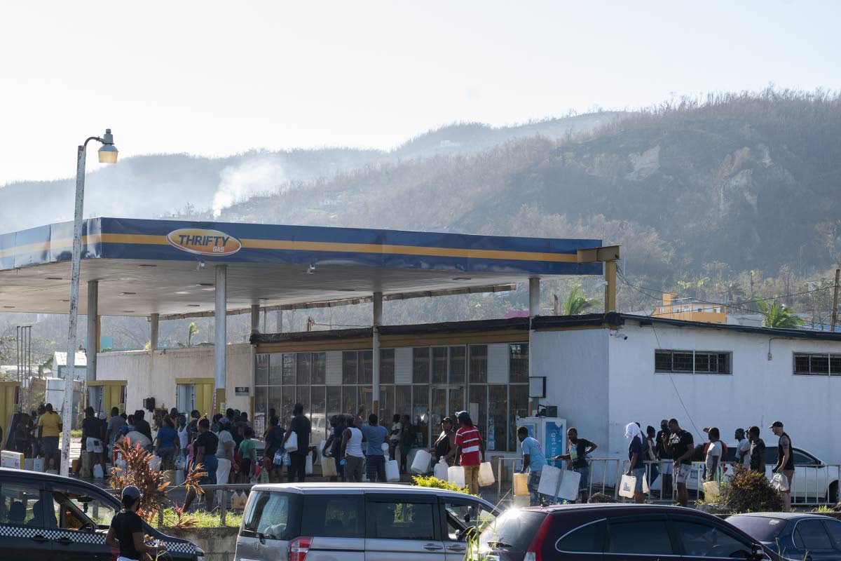 Dozens of people wait to purchase fuel from the Thrifty gas station along the Bogue road in Montego Bay, St James, on November 2. 