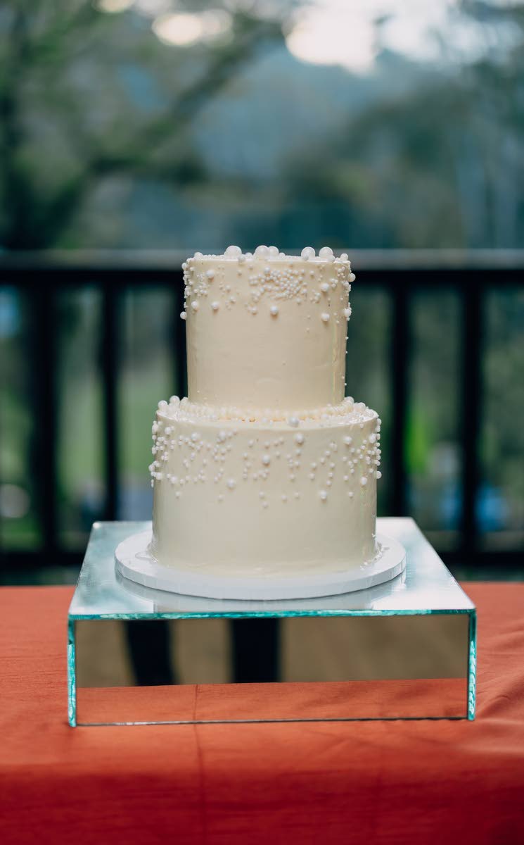 This two-tier wedding cake is made with love by Just 4 U Cake.