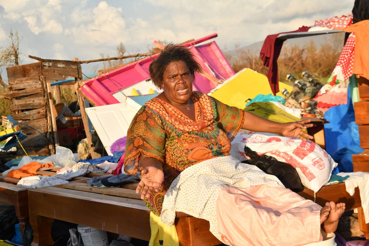 Nicola Gowdie, a resident of St Elizabeth, cries as she looks at the remains of her house that was damaged by Hurricane Melissa.