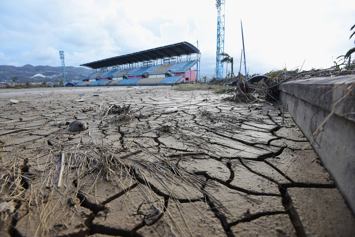 The football and track-and-field areas at Catherine Hall Sports Complex remain covered in inches of mud and silt after Hurricane Melissa.