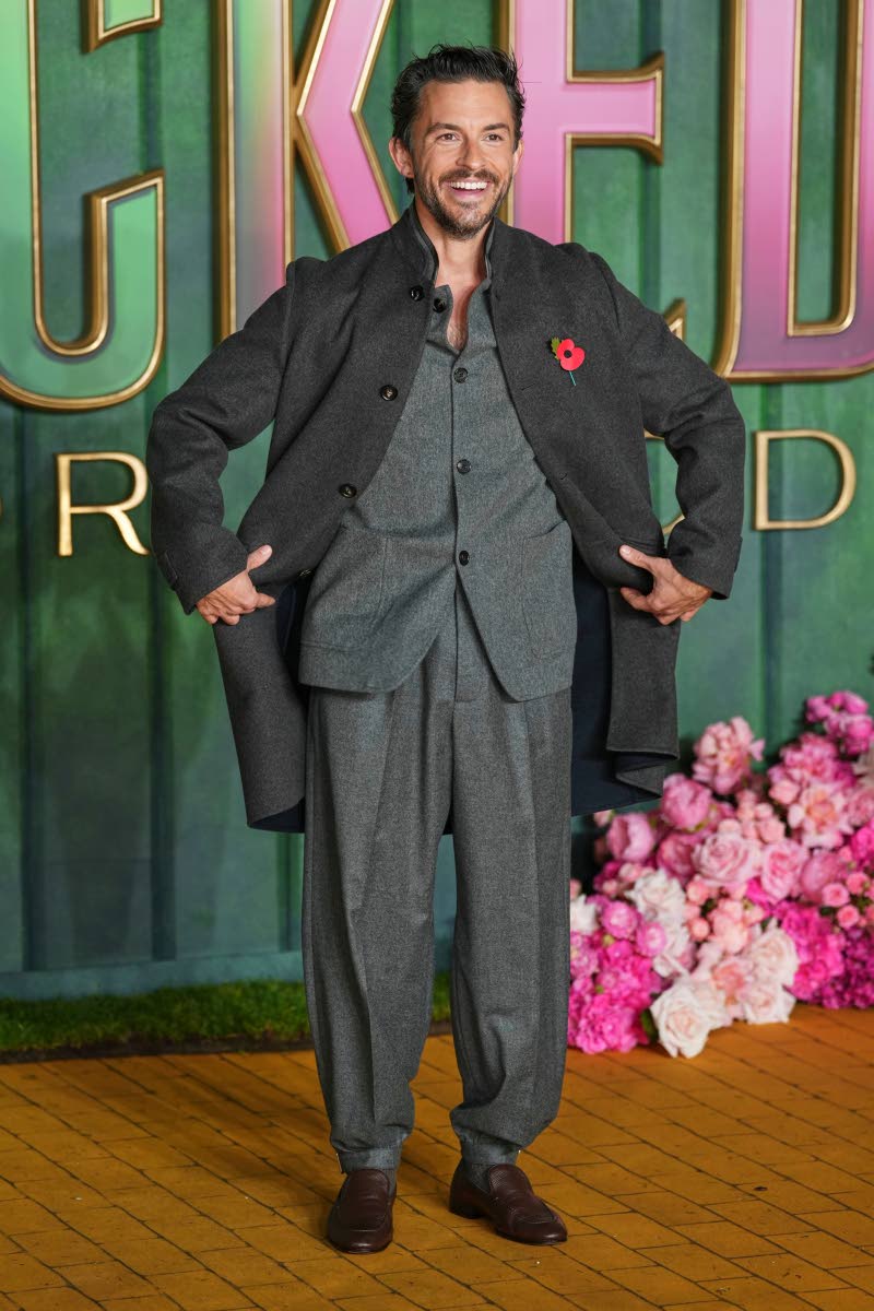 Jonathan Bailey gives a playful pose for the cameras.