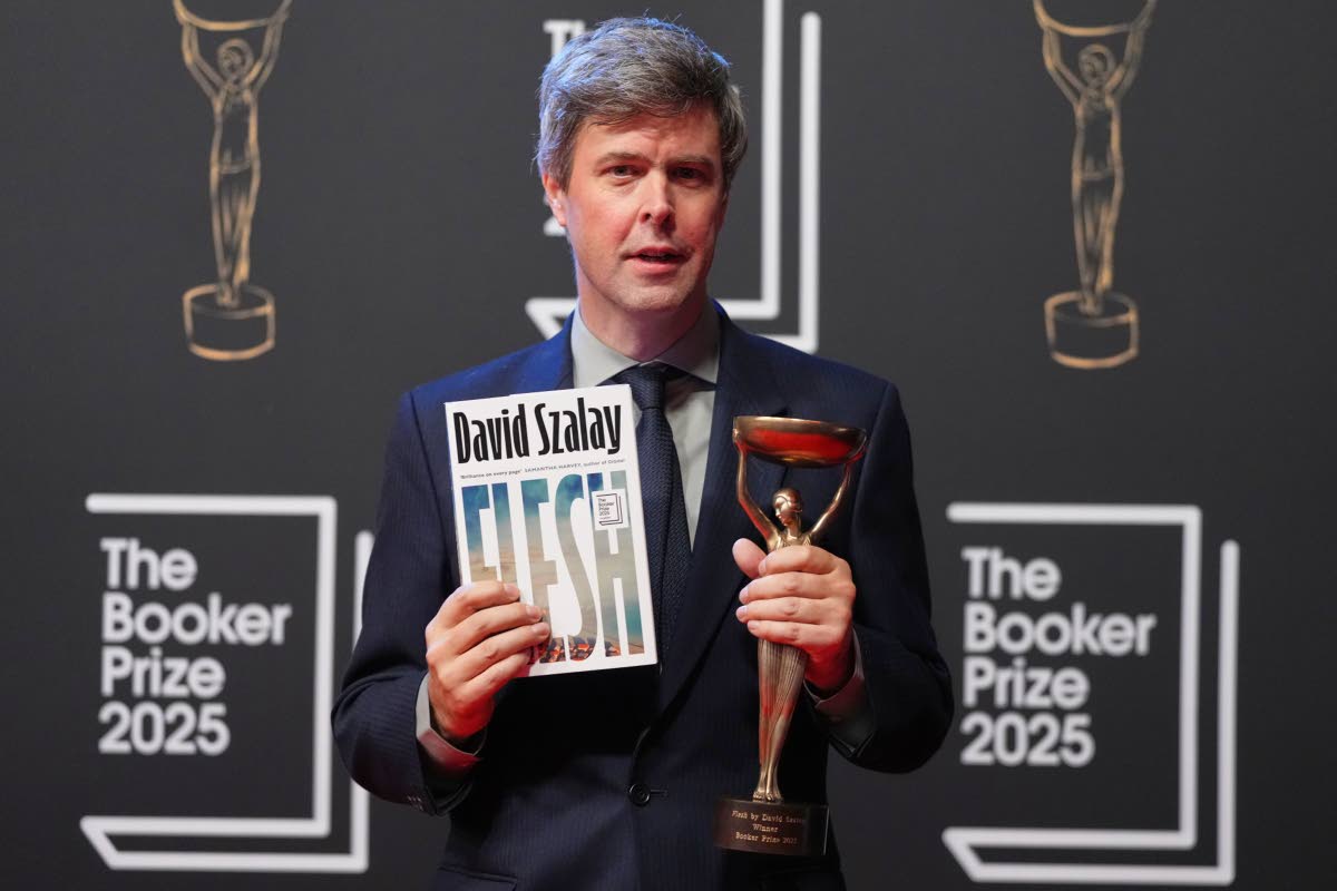 Hungarian-British author David Szalay poses for photographers with the trophy after winning the Booker Prize 2025 for his book ‘Flesh’ during a ceremony at Old Billingsgate in London, Monday. 