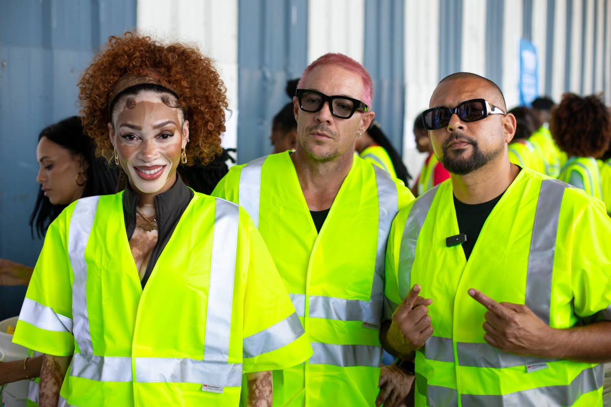 From left: Winnie Harlow, Diplo and Sean Paul assist the Food For The Poor Jamaica team package hygiene kits and other essentials for distribution.